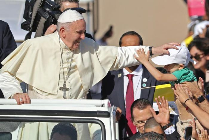 Pope Francis blesses a child as he arrives to lead a mass for an estimated 170,000 Catholics in Abu Dhabi during the first-ever papal visit to the Arabian Peninsula in February 2019