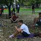 People look at their smartphones in central Moscow in August 2016 -- dating app Tinder has now been required to register with Russian security services