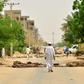 Sudanese residents walk past barricades in Khartoum on June 9, 2019