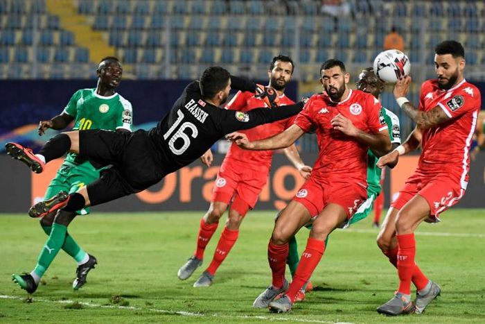 Dylan Bronn (R) of Tunisia concedes the own goal that gave Senegal victory in an Africa Cup of Nations semi-final in Cairo