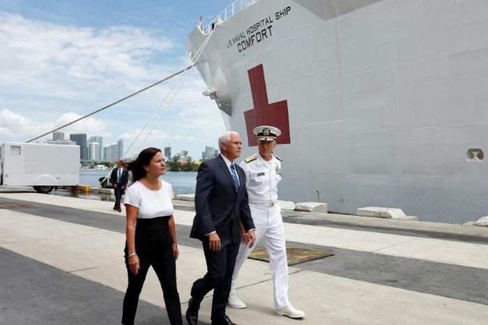 Karen Pence (L), Vice President Mike Pence (C) and Southern Command Admiral Craig Faller (R) walk past the US Naval Hospital Ship Comfort at the Port of Miami