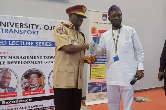 L-R: Dr Boboye Oyeyemi, Corps Marshal, Federal Road Safety Corps (FRSC) receiving a recognition award from Prof. Olanrewaju Fagbohun, Vice-Chancellor,Lagos State University (LASU) as Guest lecturer for the First Distinguished Lecture series of the LASU...