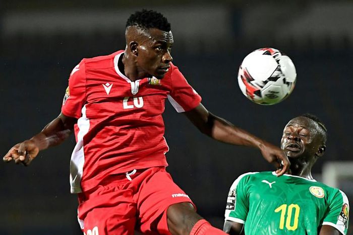 Kenya midfielder Philemon Otieno (L) heads the ball next to Senegal's forward Sadio Mane
