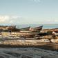 Malawian fishermen fix their fishing nets on the shores of Lake Malawi where fish stocks are falling due to overfishing and climate change