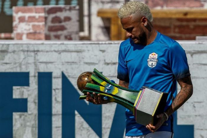 Brazilian football star Neymar holds a trophy during a five-a-side football tournament for his charity Neymar Junior Project Institute in Praia Grande, Sao Paulo, Brazil, on July 13, 2019
