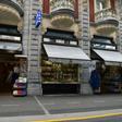 Pope Francis says he wants to see less commercialism and more piety in the Marian shrine in the French southwestern pilgrimage city of Lourdes. Visitors wait to withdraw money from a cash dispenser next to shops selling religious articles