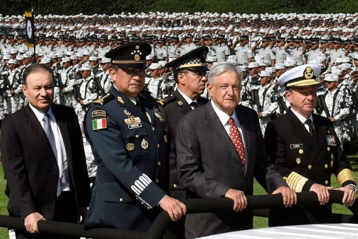 President Andres Manuel Lopez Obrador (C) and his top military brass review members of Mexico's new security force, the National Guard