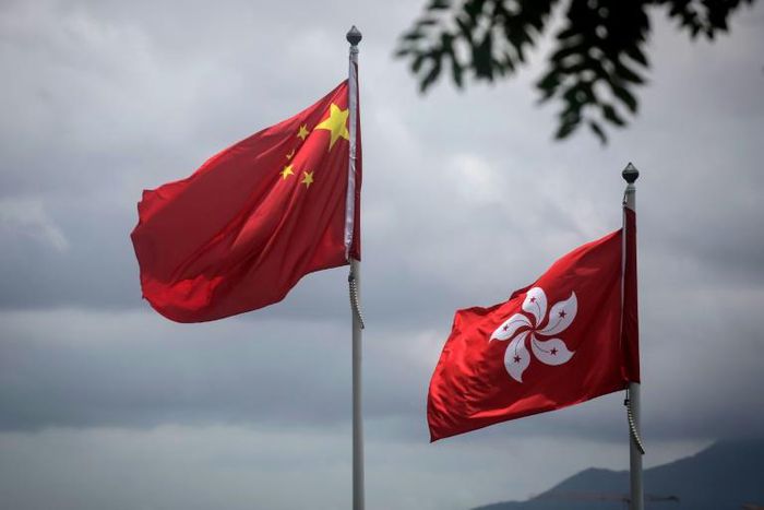 China's national flag is seen beside the Hong Kong ensign a day after protesters broke into the government headquarters in the city