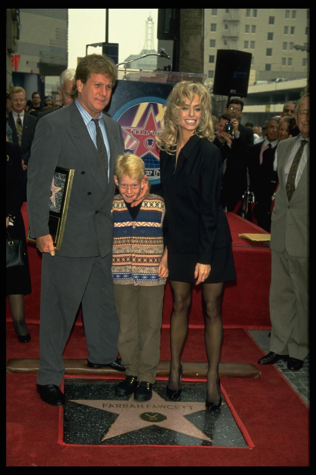 Farrah Fawcett, Ryan ONeal, and their son Redmond ONeal at ceremony honoring Farrah into Hollywoods Walk of Fame.
