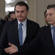 Brazilian President Jair Bolsonaro (L) and Argentine President Mauricio Macri arrive at a welcoming ceremony before holding a working meeting in Buenos Aires