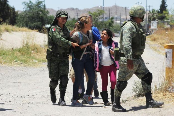 Mexican National Guard soldiers detain Central American migrants trying to cross the Rio Bravo - also known as the Rio Grande - into the United States at Ciudad Juarez
