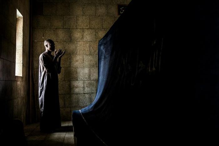 A pilgrim prays before the tomb of Usman Dan Fodio, revered by the Fulani as a holy man