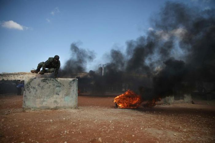 Fighters of Jaysh al-Izza, a formerly US-backed Syrian rebel group active in northern Hama province and parts of Idlib, take part in a military show near the Bab al-Hawa crossing between Idlib province and Turkey on July 18, 2019. The Syrian government...