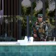 A member of the Iraqi Kurdish security forces stands guard outside the restaurant where two people were shot dead in Arbil