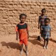 A group of children pose for photographs on a street in Agadez, northern Niger on April 1, 2017