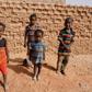 A group of children pose for photographs on a street in Agadez, northern Niger on April 1, 2017