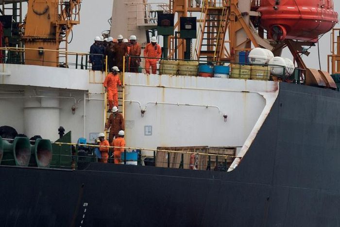 (FILES) In this file photo taken July 06, 2019 Crew members walk down a ladder on board supertanker Grace 1 off the coast of Gibraltar on July 6, 2019. Gibraltar's Chief Minister Fabian Picardo has said he had a "constructive and positive" meeting with...