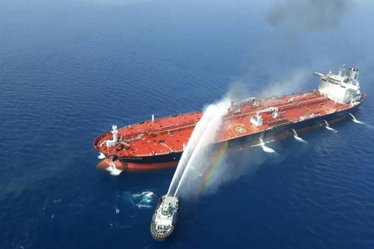 This file picture obtained by AFP from Iranian news agency Tasnim on June 13, 2019 reportedly shows an Iranian navy boat trying to control fire from Norwegian owned Front Altair tanker after it was attacked in the Gulf of Oman