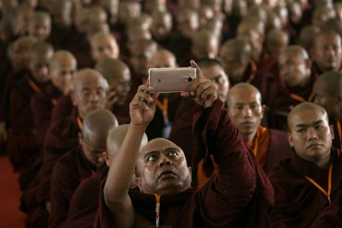 A monk takes a picture during the annual meeting of the ultra-nationalist Buddha Dhamma Parahita Foundation in Yangon