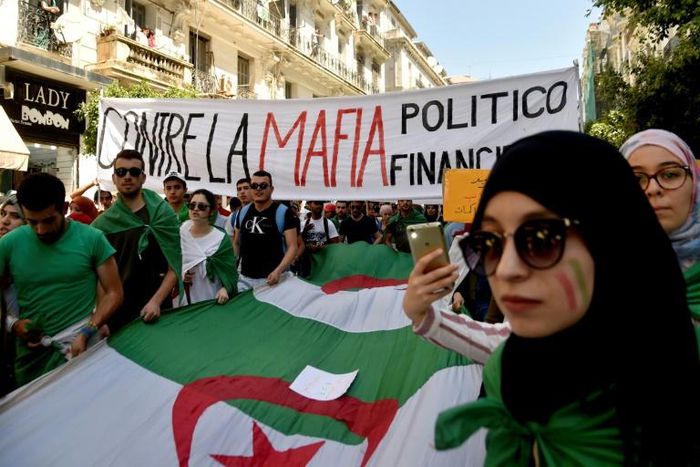 Protesting students hold a banner reading "against the politico-financial mafia" in Algiers on Tuesday