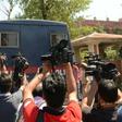 Indian media gather around a police vehicle carrying seven men accused of the brutal rape and murder of an eight-year-old nomadic girl