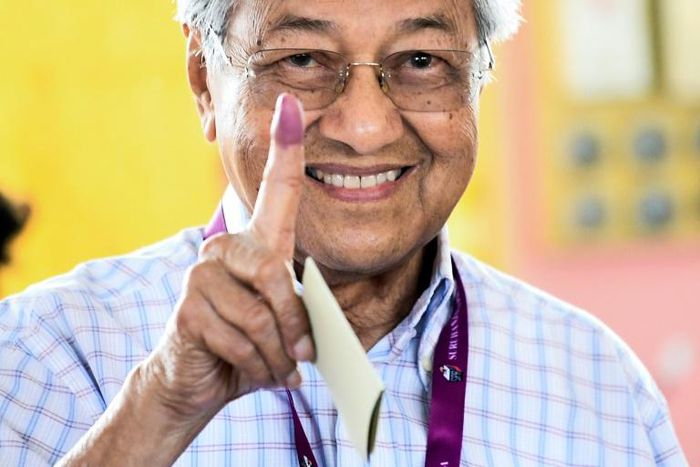 Mahathir Mohamad shows his inked finger after casting his vote in the 2018 election that saw him returned to power