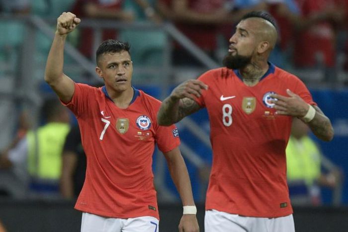 Alexis Sanchez (left) celebrates scoring the winning goal in Chile's 2-1 victory over Ecuador