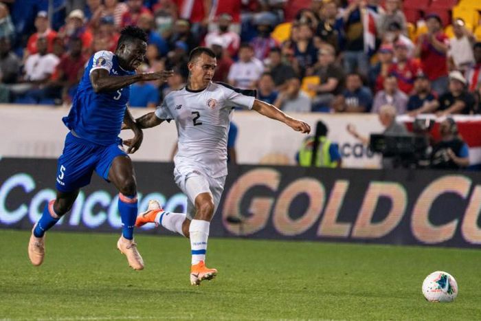 Haiti defender Djimy Bend Alexis (L) fights for the ball with Costa Rica midfielder Randall Leal in Haiti's 2-1 Gold Cup Group B victory at Red Bull Arena