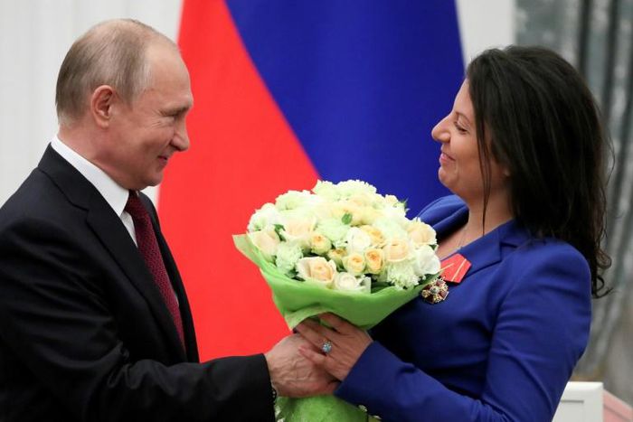 Britain has said it will bar Sputnik news and RT from a global conference on media freedom in London; in this image from May 23 2019, Russia's President Vladimir Putin presents flowers to editor-in-chief of Russian broadcaster RT Margarita Simonyan aft...