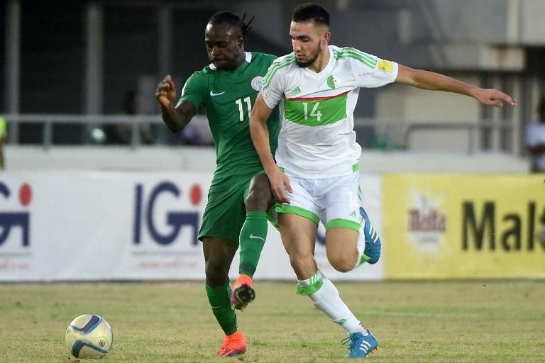 Algeria's midfielder Nabil Bentaleb (R) challenges Nigeria's midfielder Victor Moses during the 2018 FIFA World Cup African zone group B qualifying football match between Nigeria and Algeria at the Akwa Ibom State Stadium in Uyo on November 12, 2016