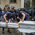 This handout picture released by the Italian police (Polizia di Stato) of Turin, on July 15, 2019, shows italian policemen carry an air-to-air missile, as part of a big cache of guns and ammunition that was seized by the Turin special police force, cal...