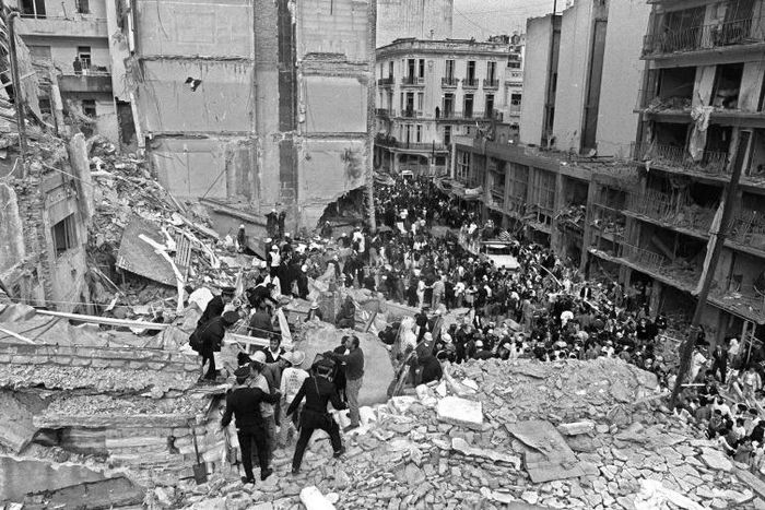 Firemen search for wounded people after a bomb exploded at the Argentine Israelite Mutual Association in Buenos Aires on July 18, 1994