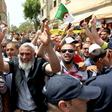 Protesters demonstrate as Algeria's former prime minister Abdelmalek Sellal is driven to custody in Algiers on June 13