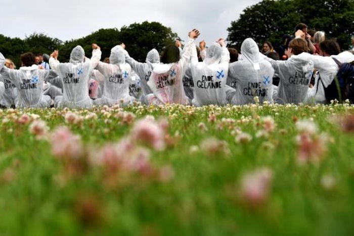 European climate activists, in their trademark white overalls, take part in a training in Viersen, western Germany, on the eve of their mass action aiming to block a huge open-pit coal mine.