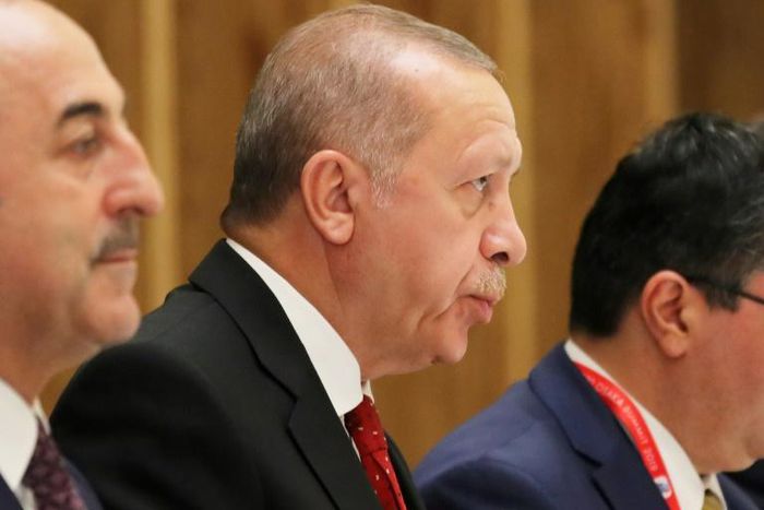 Erdogan (C) supports the internationally recognised national unity government in Tripoli
