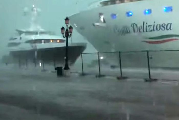 This photo grabbed from a video taken on July 7, 2019 and obtained on July 8, 2019 from Roberto Ferrucci (www.robertoferrucci.com) shows the 292-meter-long Costa Deliziosa cruise ship (right) close to a yacht (left) as it left Venice