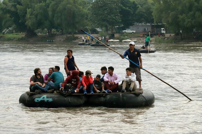 Locals and Central American migrants use a makeshift raft across the Suchiate river from Tecun Uman in Guatemala, to Ciudad Hidalgo in Chiapas State, Mexico, on June 11, 2019