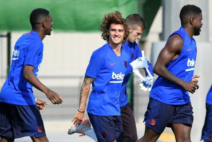 Barcelona's French forward Antoine Griezmann laughs as he runs during the football club's first pre-season training session.