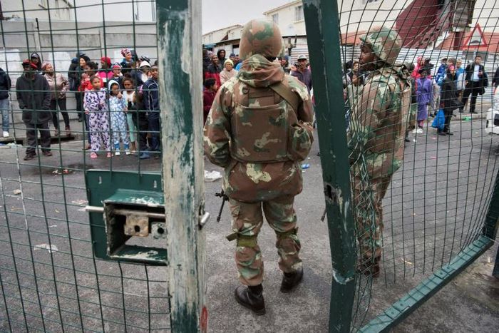 South African National Defense Force troops patrol a Cape Town street in one of the areas ravaged by gang violence