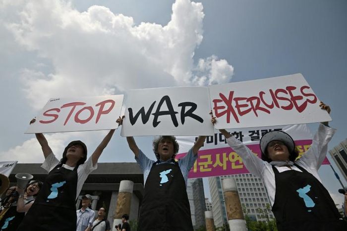 Anti-war activists hold placards reading "Stop War Exercises" during a rally against planned South Korea-US annual joint military exercises near the US embassy in Seoul on August 5, 2019
