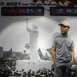 A man stands in front of a photo from the 1989 Tiananmen Square protests at a museum in Hong Kong