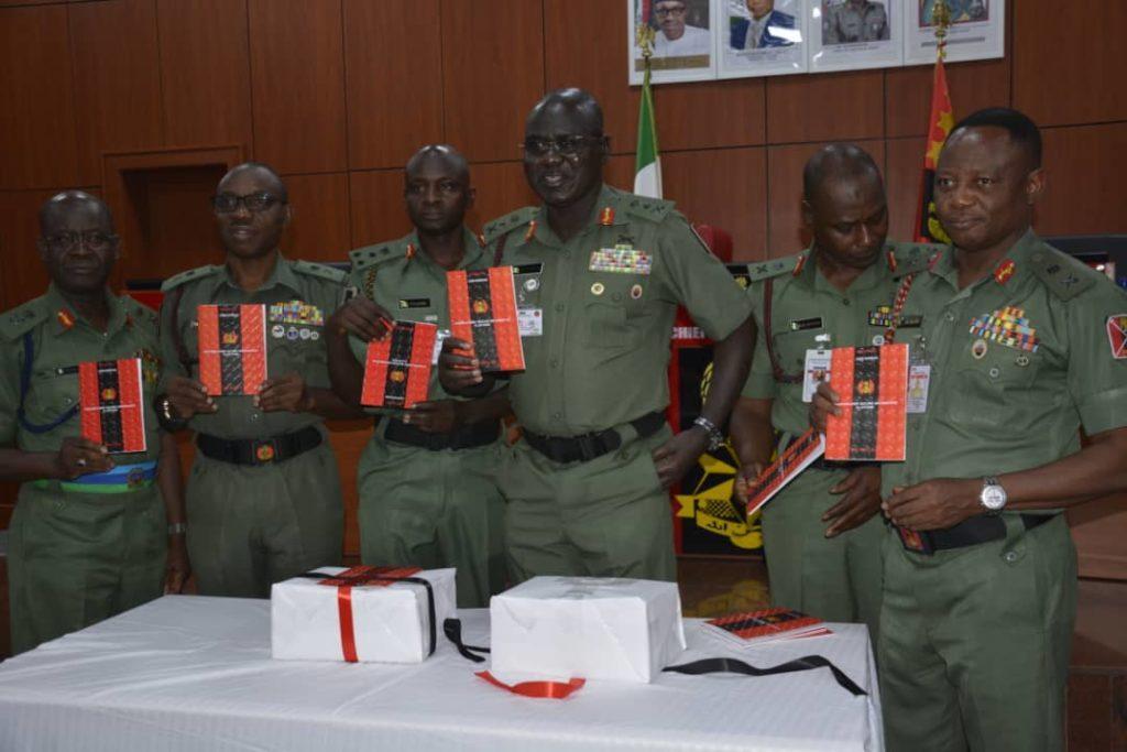3rd from (r), Chief of Army Staff, Lt.-Gen. Tukur Buratai and some Principal Staff (PSO) at the Army Headquarters, displaying copies of newly inaugurated Nigerian Army Secured Information Platform (NASIP) on Monday in Abuja. [NAN]