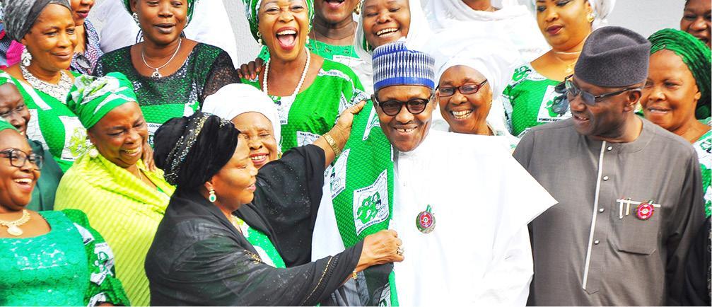 President Muhammadu Buhari being decorated by the National President, National Council of Women Societies of Nigeria, Mrs Gloria Laraba Shoda, during a visit by a delegation from the council to the Presidential Villa in Abuja yesterday [Daily Trust]