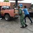 People push a vehicle up to the pump to fill up on gas at a station in Acarigua in Venezuela, which has started rationing fuel
