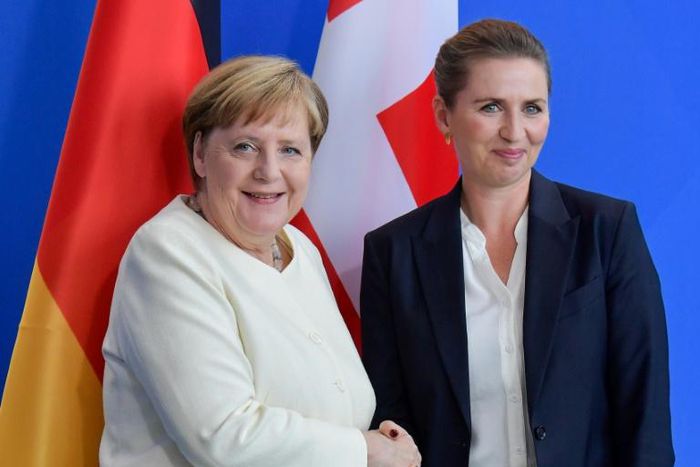 German Chancellor Angela Merkel remained seated as national anthems were played at a ceremony with Denmark's new Prime Minister Mette Frederiksen
