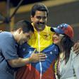 In this 2013 photo, Venezuelan acting President Nicolas Maduro (C) embraces his wife Cilia Flores (R) and son Nicolas Maduro during a campaign rally -- Maduro's son is now the target of US economic sanctions