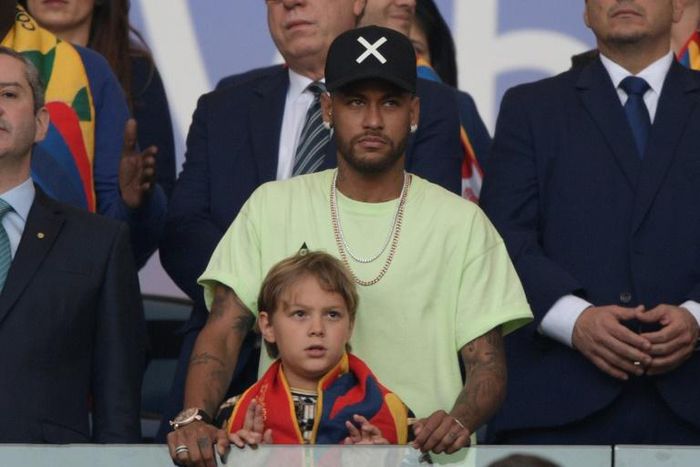 Brazilian injured footballer Neymar and his son Davi Lucca are seen on the stands before the Copa America football tournament final match in Rio de Janeiro, Brazil, on July 7, 2019. Neymar failed to show up for pre-season training with Paris Saint-Germ...