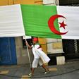 An Algerian man clad in a national flag takes part in a demonstration in the capital Algiers on June 14