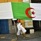 An Algerian man clad in a national flag takes part in a demonstration in the capital Algiers on June 14