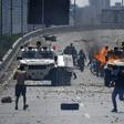 Supporters of Venezuelan opposition leader and self-proclaimed acting president Juan Guaido clash with forces loyal to President Nicolas Maduro in front of La Carlota military base in Caracas on April 30, 2019